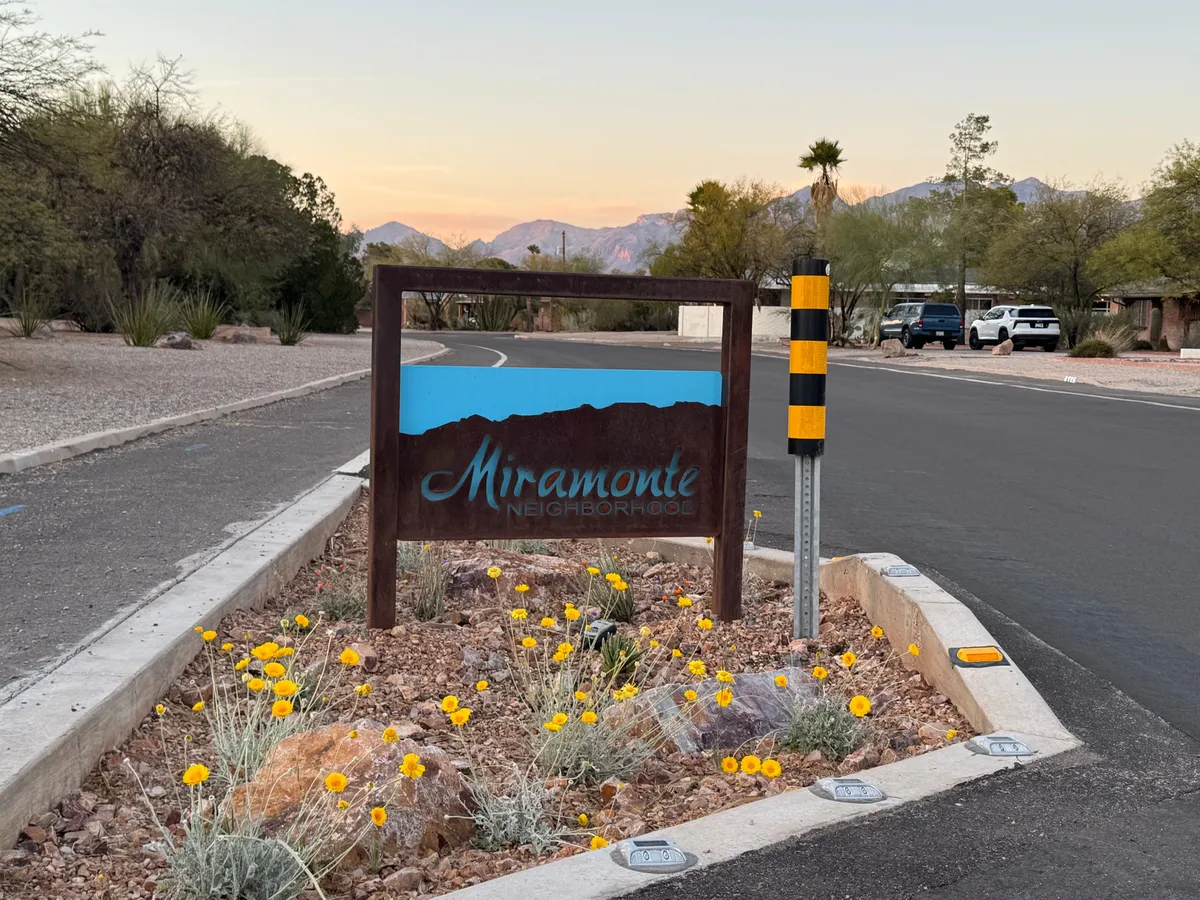 Planted median with yellow wildflowers and the Miramonte sign