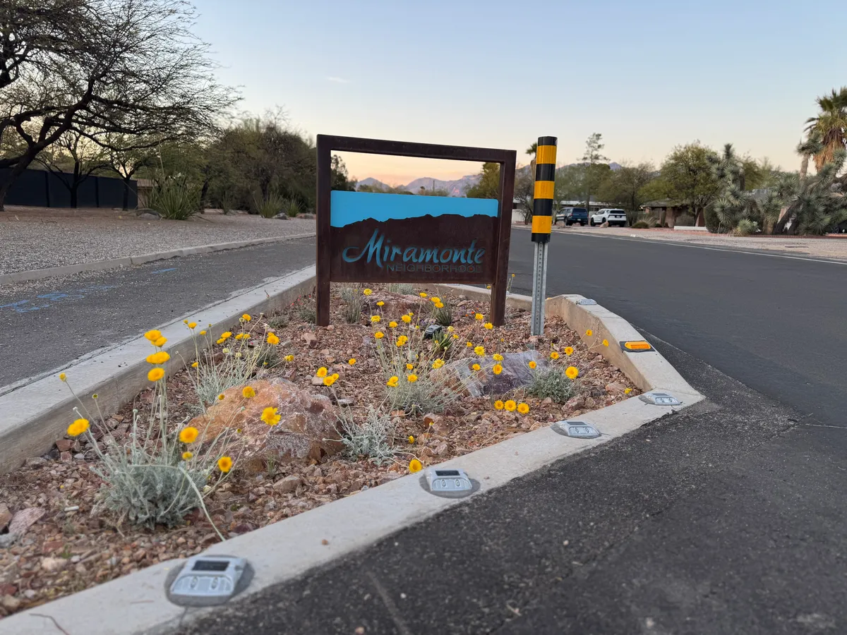 The Miramonte entrance sign framed by desert wildflowers
